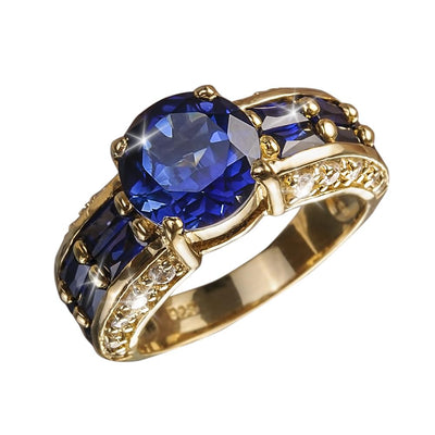 Azura Ring featuring a large blue gemstone centerpiece set in gold-plated sterling silver with additional blue stones and accent diamonds, designed for women’s jewelry.