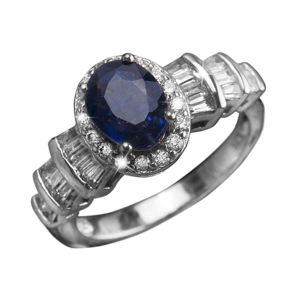 Blue Symphony Ring featuring a sterling silver band with rhodium plating, centered by an oval deep blue gemstone surrounded by sparkling clear crystals, designed for females.