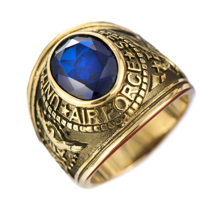 Airforce Ring crafted from gold-plated stainless steel featuring a large blue gemstone centerpiece, designed as a bold men’s collectible jewelry piece.