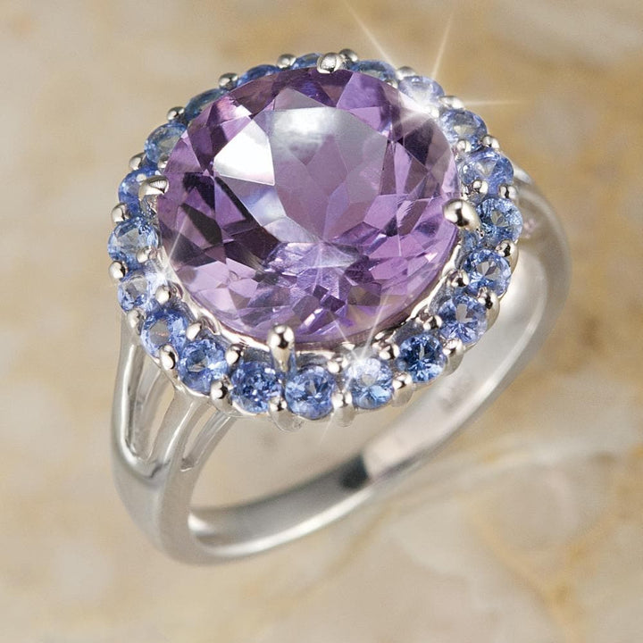 Amethyst & Tanzanite Cocktail Ring featuring a large round amethyst center stone surrounded by smaller tanzanite stones set in sterling silver with rhodium plating, designed for women.