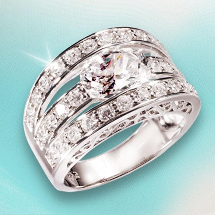Verona Ring crafted in sterling silver with rhodium plating, featuring a wide band design encrusted with multiple sparkling stones for an elegant female jewelry statement.